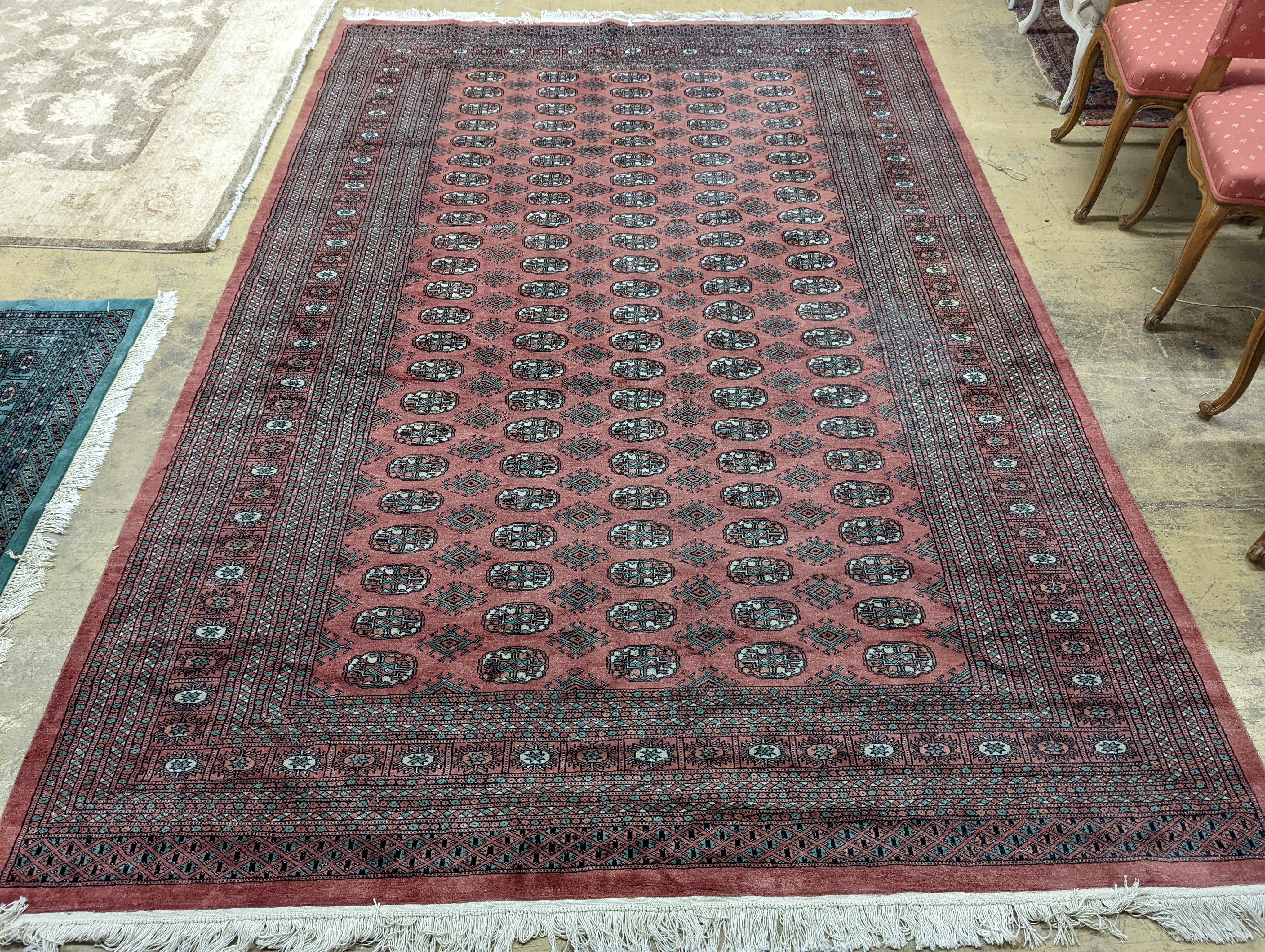 A pink ground Bokhara carpet, 315 x 220cm